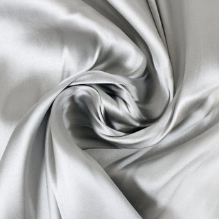 swirl of silver silk serge fabric, demonstrating its drapability