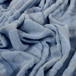 close-up of a sky blue colored knit patterned-velour fabric