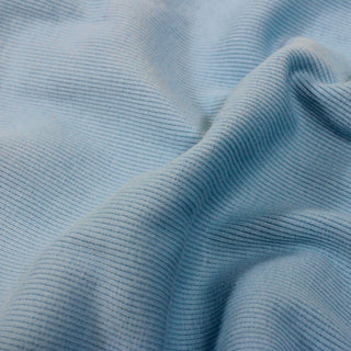 close-up of sky blue colored rib knit jersey fabric, detailing the rib knit face