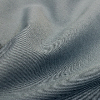close-up of slate blue twill fabric, detailing the two-toned weave and subtle sheen