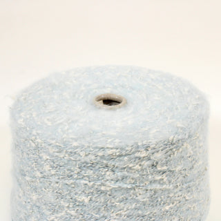 close-up of a large cone of a textured light blue yarn with white flecks