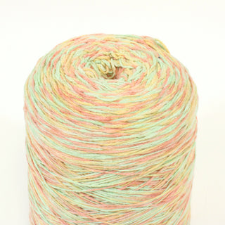 close-up of a cone of multicolor core yarn in sorbet pastel color palette of green, yellow, and peach
