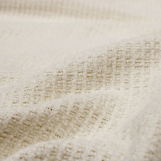 close-up of sparkly snowflake tweed fabric, detailing the weave structure and subtle lurex flecks of sparkle