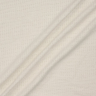 sparkly snowflake tweed fabric draped in three lines to demonstrate the slightly structured drape