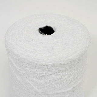 close-up of a large cone of stark white eyelash yarn, detailing the texture