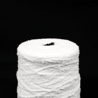 close-up of a large cone of stark white eyelash yarn, detailing the texture