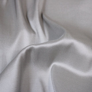 close-up of sterling silver silk taffeta fabric showing its sheen face
