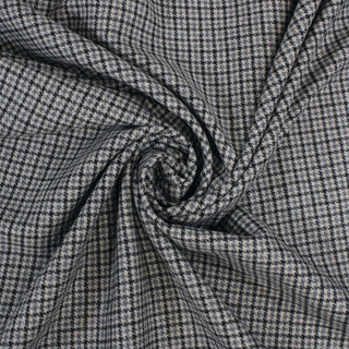 spiral of a wool houndstooth fabric, demonstrating its soft and moderate drape