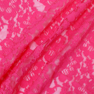 three diagonal lines draped of a pink stretch lace floral mesh fabric, demonstrating its sheer nature, drapeability, and lightweight hand