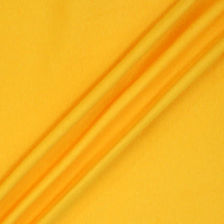 sunshine yellow colored 1x1 rib knit jersey fabric arranged with three draped lines on the surface to demonstrate soft and stretchy drape