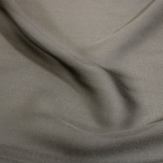 close-up of taupe colored silk chiffon fabric with a slightly rough hand