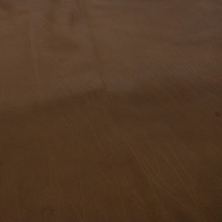 face of a calfskin leather hide in a deep teak brown color