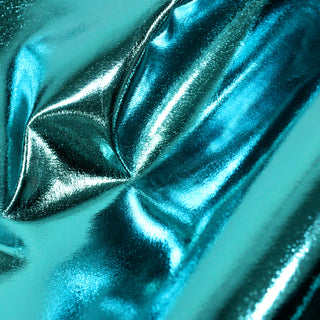 Close-up of teal metallic fabric with folds