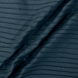 three diagonal lines draped of teal colored rib-knit fabric