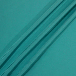 teal silk lining fabric with three diagonal peaks arranged to demonstrate the lightweight hand and soft drape