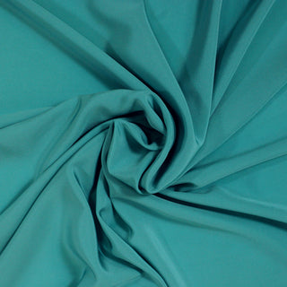 swirl of teal colored silk lining fabric, demonstrating the drape and hand