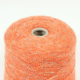 close-up of tiger orange colored curly yarn with white and brown flecks