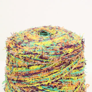 close-up of a multicolored raggy fine-gauge eyelash yarn cone detailing the fibers