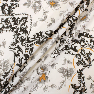 three diagonal lines draped of an off-white broadcloth fabric with dark brown and ochre colored motifs blockprinted across it