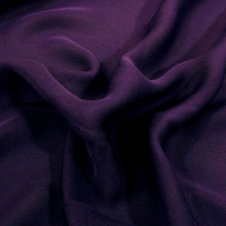 close-up of a violet colored silk chiffon fabric, detailing its weave structure