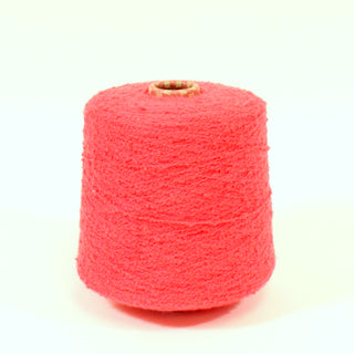 a cone of watermelon colored boucle yarn