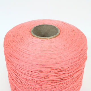 close-up of a large cone of watermelon colored fine-gauge worsted yarn