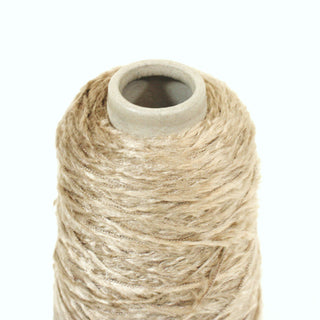 close-up of a small cone of wheat colored eyelash yarn with a subtle shine