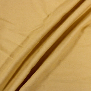 three diagonal lines draped of a pale yolk yellow colored duck canvas, demonstrating its thick, textured hand, and stiff quality