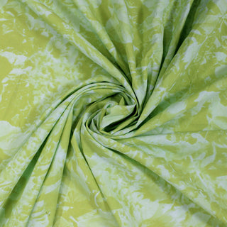 swirl of a green and blue abstract fabric, demonstrating the drape and shine of the fabric