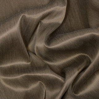 Close up of an antique gold upholstery fabric, detailing the surface shine.