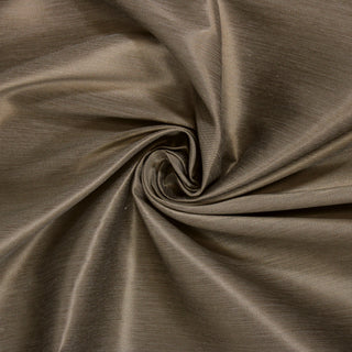 Swirl of an antique gold upholstery fabric, detailing the drape and surface shine.