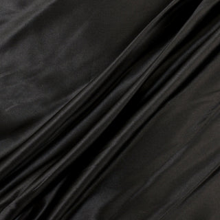 three diagonal lines draped of a black silk stretch charmeuse fabric