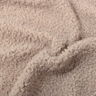 close-up of blush colored fleece fabric, detailing the high pile and faux-sherpa like texture