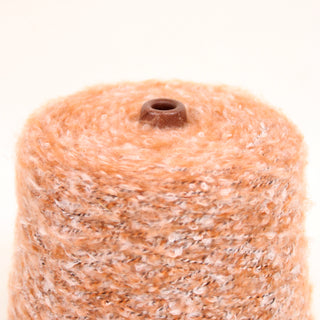 Close up of loop yarn n a white background, detailing the surface shine.