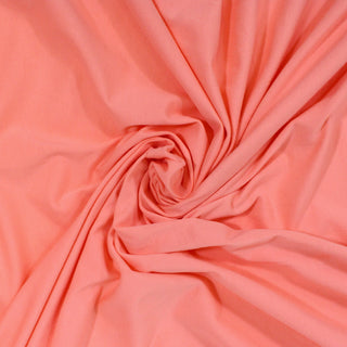 swirl of a coral colored jersey fabric