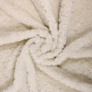Swirl of a cream long pile faux fur, detailing the drape.