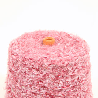 Closeup of pink and white cone of loop yarn on a white background.