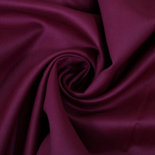 Swirl of eggplant purple bengaline fabric, detailing the surface shine and drape.