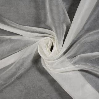 swirl of an ivory silk organza fabric photographed on top of a black fabric background to show the very subtle woven-in large-scale floral pattern