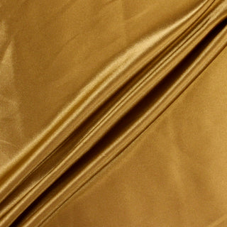 Three lines draped of a gold poly satin fabric