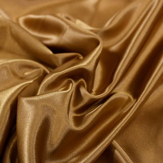 Close up of a gold poly satin fabric, detailing the surface shine