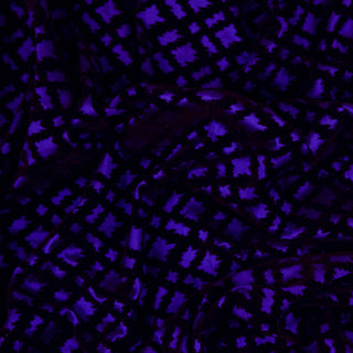 Close up of a gothic flocked fabric, detailing the surface shine and drape.