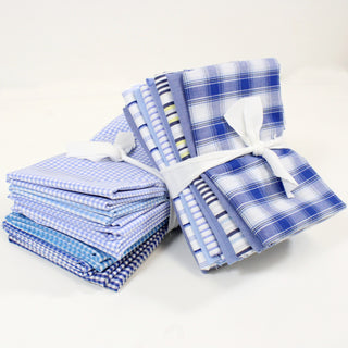 two stacks of folded blue and white quilting fabrics, each a 10 pack of half-yard pieces
