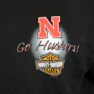 Black shirt with red 'N', 'Go Huskers!' text, and Harley-Davidson logo.