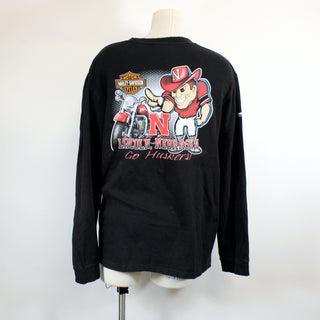 Black long-sleeve shirt with a graphic design on a mannequin against a white background