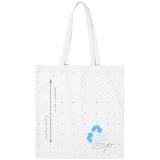 Front side of a white recycled-fabric tote bag with blue-gridded sewing-pattern-paper print, featuring blue limited-edition 10 year FABSCRAP logo, as well as graphite grey puff screenprint handwritten details.