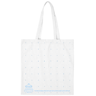 Backside of a white recycled-fabric tote bag with a blue screenpritened gridded pattern across it alluding to sewing pattern paper