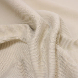 Closeup of a khaki rib knit jersey, detailing the surface shine.