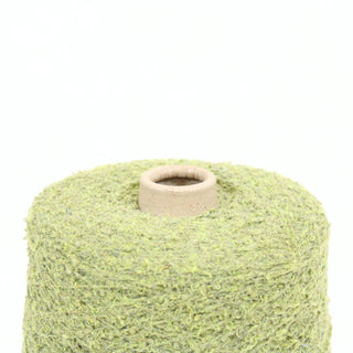 Close up of green loop yarn on a white background, detailing the texture
