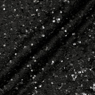 Three lines draped of a black sequin tweed fabric.